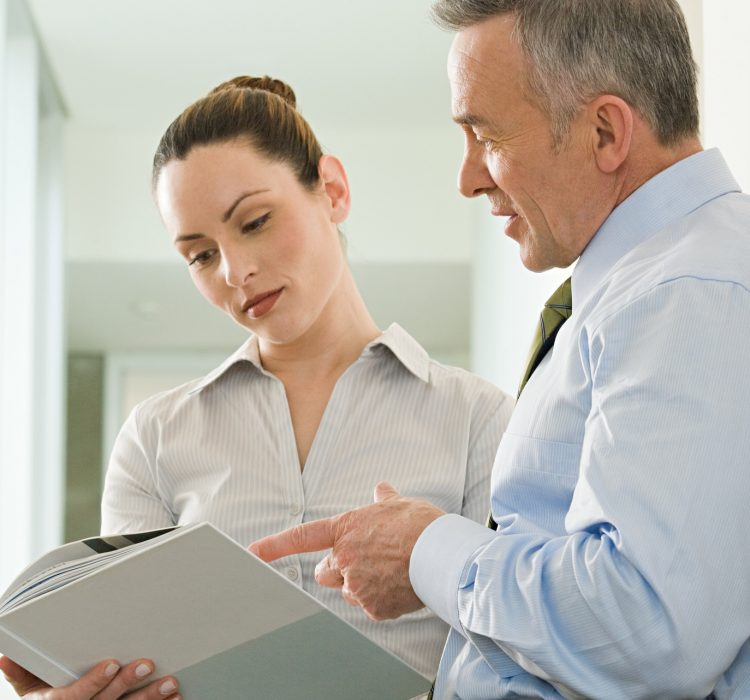 Two business colleagues reading a document